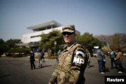 FILE - A U.S. Army soldier stands guard in front of the Peace House at the truce village of Panmunjom inside the demilitarized zone separating the two Koreas, South Korea, April 18, 2018.