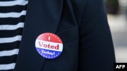 Lisa O. wears an "I Voted Today!" sticker after casting her vote during early voting at City Hall in Philadelphia, Pennsylvania on October 7, 2020. (Photo by GABRIELLA AUDI / AFP)