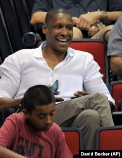 Toronto Raptors general manager Masai Ujiri watches his team play against Denver Nuggets during an NBA summer league basketball game on Saturday, July 12, 2014, in Las Vegas. Ujiri is from Nigeria.