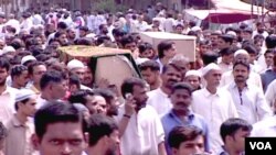 Warga Pakistan memakamkan para korban tewas akibat kekerasan politik dan etnis di Karachi (19/8).