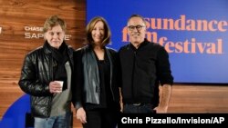FILE - Sundance Institute founder Robert Redford, from left, executive director Keri Putnam and Sundance Film Festival program director John Cooper pose at the opening press conference of the 2018 Sundance Film Festival, Jan. 18, 2018, in Park City, Utah.
