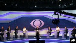 Brazil's presidential candidates before the start of a debate in Sao Paulo, Brazil. From left are Alvaro Dias of Podemos Party, Cabo Daciolo of Patriota Party, Geraldo Alckmin of the Social Democratic Party, Marina Silva of the Sustainability Network Party, Jair Bolsonaro of the National Social Liberal Party, Guilherme Boulos of the Socialism and Liberty Party, Henrique Meirelles of the Democratic Movement Party, and Ciro Gomes of the Democratic Labor Party. 