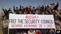 Demonstrators gather during a protest against Syria's President Bashar al-Assad and Russia in Kafranbel near Idlib, January 20, 2012