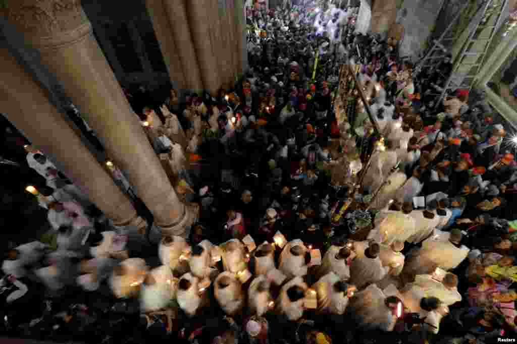 Members of the Catholic clergy hold candles during Easter procession in the Church of the Holy Sepulchre in Jerusalem&#39;s Old City, April 5, 2015.