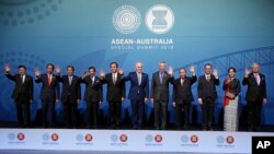 Leaders, from left to right; Prime Minister of Laos Thongloun Sisoulith, Indonesia's President Joko Widodo, Cambodia's Prime Minister Hun Sen, Brunei's Sultan Hassanal Bolkiah, Thailand's Prime Minister Prayuth Chanocha, Australia's Prime Minister Malcolm Turnbull, Singapore's Prime Minister Lee Hsien Loong, Vietnam's Prime Minister Nguyen Xuan Phuc, Philippines' Secretary of Foreign Affairs Alan Peter Cayetano, Myanmar's leader Aung San Suu Kyi, and Malaysia's Prime Minister Najib Razak, pose for a group photo at the Association of Southeast Asian Nations, ASEAN, special summit, in Sydney, Saturday, March 17, 2018. Australia is hosting leaders from the 10-country Association of Southeast Asian Nations during the 3-day special summit. (AP Photo/Rick Rycroft)