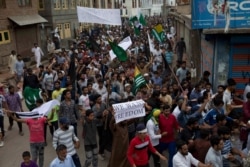 Protesters march on a street after Friday prayers in Srinagar, Indian-controlled Kashmir, Aug. 9, 2019.