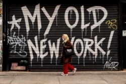 A person walks by a closed business on April 16, 2020, in New York City.
