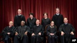 The justices of the U.S. Supreme Court gather for a formal group portrait at the Supreme Court Building in Washington, Nov. 30, 2018.
