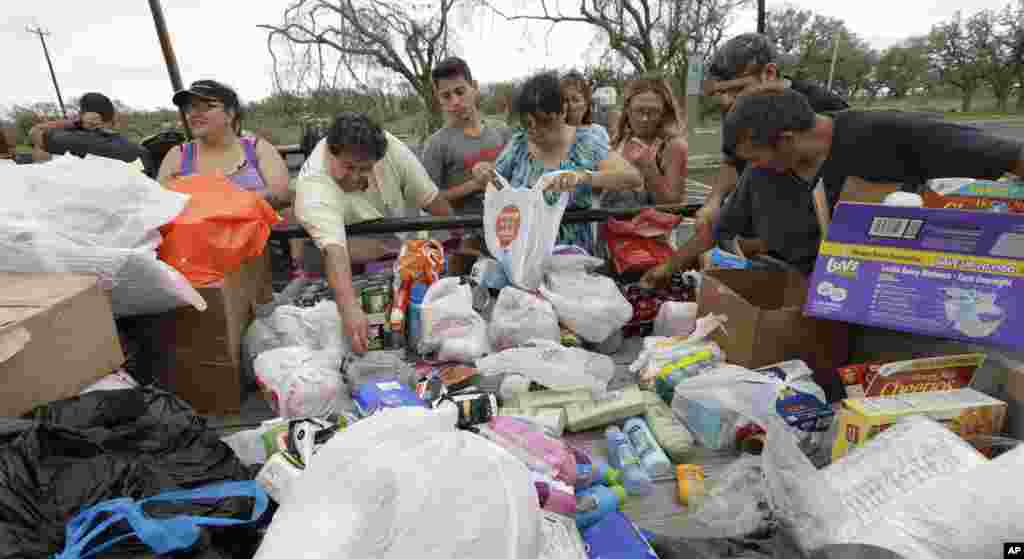 Residents pick through needed items at a make-shift aid station, Sunday, Aug. 27, 2017, in Rockport, Texas. A group from the Texas Rio Grande Valley created station for those in need following Hurricane Harvey. (AP Photo/Eric Gay)