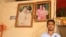 Suon Sakhen, spouse of the victim, stands in front of his wedding photos inside his house, in Chantrea district, Svay Rieng province, Feb 8, 2019. (Sun Narin/VOA Khmer) 