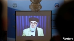 FILE - A screen shows the broadcast of Gulbuddin Hekmatyar during a signing ceremony with Afghan government at the presidential palace in Kabul, Afghanistan, Sept. 29, 2016.