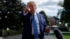 President Donald Trump talks to reporters on the South Lawn of the White House, Oct. 4, 2019, in Washington.
