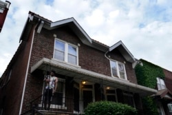 A man stands outside of the home of Craig Elazer in St. Louis on Friday, May 21, 2021.