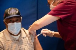 Edmond Lomas III receives his COVID-19 vaccination at Second Ebenezer Church in Detroit, Feb. 27, 2021.