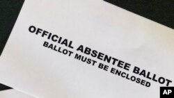 A Cobb County Ga., absentee ballot is seen Tuesday, May 5, 2020, in Kennesaw, Ga. Presidential Preference Primary, General Primary Election, Nonpartisan General Election, and Special Election. will be held June 9, 2020, in Georgia. (AP Photo/Mike…