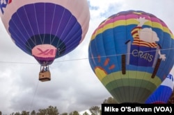 Balloons lifting off.