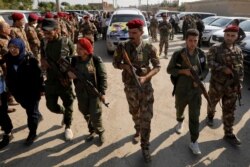 FILE - Fighters of Syrian Democratic Forces (SDF) take part in a funeral procession for comrades killed during clashes in the northeastern Syrian town of Ras al-Ayn, in the town of Qamishli, Syria, Oct, 22, 2019.