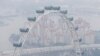 FILE - The Singapore Flyer observation wheel is shrouded by haze in this September, 2014 photo.