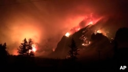 In a photo provided by Inciweb shows the Eagle Creek wildfire burning in the Columbia River Gorge east of Portland, Oregon, Sept. 4, 2017.