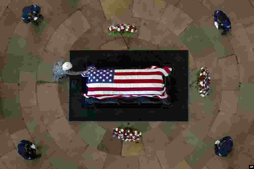 Landra Reid touches the casket of her husband, former Sen. Harry Reid, D-Nev., as he lies in state in the Rotunda of the U.S. Capitol, Jan. 12, 2022, in Washington.