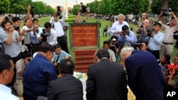 Cambodian and foreigner reporters pay respects during a ground-breaking ceremony for a memorial to journalists killed during the Cambodian conflict, south of Phnom Penh, file photo. 