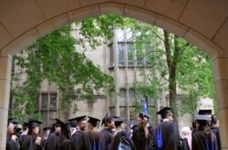 FILE - Future graduates wait for the procession to begin for commencement at Yale University in New Haven, Conn., May 24, 2010.