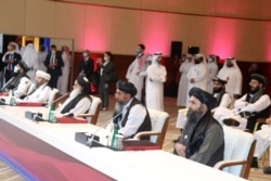 Members of the Taliban delegation attend the opening session of peace talks between the Afghan government and the Taliban, in Doha, Qatar, Sept. 12, 2020.