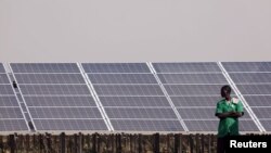 FILE - Solar panels are seen during the inauguration ceremony of the solar energy power plant in Zaktubi, near Ouagadougou, Burkina Faso, Nov. 29, 2017. 