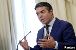 FILE - Macedonian Foreign Minister Nikola Dimitrov speaks during a news conference in Athens, Greece, June 14, 2017.