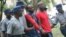 FILE: Occupy Africa Leaders Itai Dzamara (left) and Tichaona Danho (right) detained by police