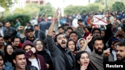 Protesters shout slogans during a protest against the Citizenship Amendment Bill, that seeks to give citizenship to religious minorities persecuted in neighboring Muslim countries, inside amia Millia Islamia University in New Delhi, India, Dec. 14, 2019.