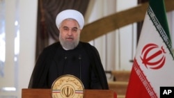 In this photo released by his office, Iranian President Hassan Rouhani addresses his nation in a televised speech, in Tehran, Oct. 13, 2017. Rouhani spoke after U.S. President Donald Trump angrily accused Iran of violating the spirit of the 2015 nuclear accord and demanded Congress toughen the law governing U.S. participation.