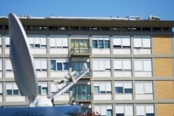 FILE - A satellite dish of a TV truck is parked in front of the Agostino Gemelli hospital, where Pope Francis has been hospitalized, in Rome, July 9, 2021.