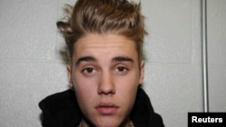 Canadian pop singer Justin Bieber is pictured in police custody in Miami Beach, Florida January 23, 2014 in this Miami Beach Police Department handout released to Reuters on March 4, 2014.