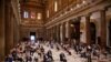 People attend a vigil prayer for the deceased would be migrants in Rome's Basilica of Our Lady in Trastevere on the World Day of Migrants, June 18, 2020.