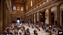 People attend a vigil prayer for the deceased would be migrants in Rome's Basilica of Our Lady in Trastevere on the World Day of Migrants, June 18, 2020.