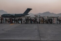 FILE - Evacuees wait to board a Boeing C-17 Globemaster III during an evacuation at Hamid Karzai International Airport, Kabul, Afghanistan, Aug. 23. (US Marine Corps photo)