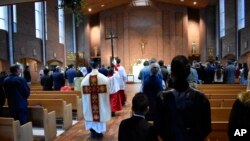 Parishioners attend mass at St. Anthony Catholic Church in Laurel, Montana on Sunday, April 26, 2020. Churches in Montana resumed services Sunday as the state took began to lift some restrictions imposed over the coronavirus. (AP Photo/Matthew Brown)