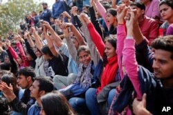 Indian students shout slogans during a protest at Jawaharlal Nehru University against the arrest of a student union leader in New Delhi, India, Feb. 16, 2016.