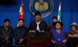 FILE - Bolivia's President Evo Morales, center, speaks during a press conference at the military base in El Alto, Bolivia, Nov. 10, 2019.