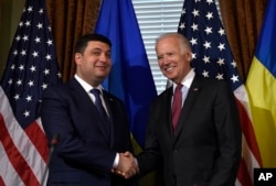 FILE - Vice President Joe Biden shakes hands with Ukraine Prime Minister Volodymyr Groysman in Biden's ceremonial office on the White House complex in Washington, June 15, 2016.