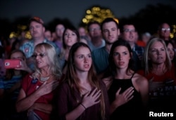 Supporters of Republican U.S. presidential nominee Donald Trump recite the Pledge of Allegiance at a campaign rally in Panama City, Florida, Oct. 11, 2016.