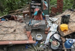 Residents salvage their belongings from the rubble of a damaged house in the aftermath of Cyclone Amphan, in South 24 Parganas district in the eastern state of West Bengal, India, May 22, 2020.