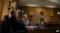 Sen. Rand Paul, R-Ky., left, and Sen. Rob Portman, R-Ohio, pose questions to witnesses as the Senate Committee on Foreign Relations holds a hearing on relations between the U.S. and Russia, on Capitol Hill in Washington, Aug. 21, 2018. 