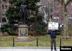 A supporter of U.S. Republican presidential candidate Donald Trump stands nearby during an interfaith rally at New York's City Hall in Manhattan, Dec. 9, 2015.