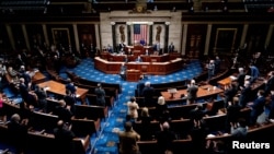 FILE - Republican and Democrats clap while House Minority Leader Kevin McCarthy (R-CA) commends Capitol Police and law enforcement for their work after rioters supporting President Donald Trump breached the Capitol.