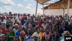 People displaced by conflict listen to a speech by the UN delegation in Komanda, Ituri province, eastern Democratic Republic of Congo, Aug. 30, 2023.