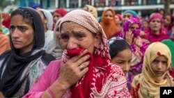 Kashmiri women grieve as they watch funeral of Showkat Ahmed Lohar, a local militant in Arwani, about 55 kilometesr (35 miles) south of Srinagar, India, July 18, 2017. Indian soldiers and police killed three suspected rebels during a brief gun battle Mond