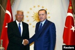 FILE - Turkey's President Tayyip Erdogan (R) shakes hands with Secretary General of the Council of Europe Thorbjorn Jagland before a meeting at the Presidential Palace in Ankara, Turkey, Aug. 3, 2016.