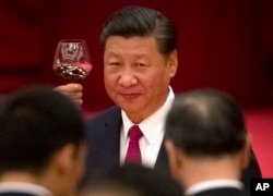 FILE - Chinese President Xi Jinping toasts during a reception at the Great Hall of the People on the eve of the Oct. 1 National Day holiday in Beijing.